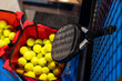 paddle tennis racket and balls on court, 