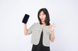 Asian woman is posing okay to a mobile phone on a white background.