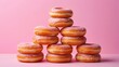 Stack of delicious donuts on pink background, closeup. Delicious dessert