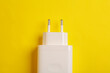 Adapter for charging smartphone on yellow background