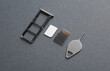 Tray with SIM and micro SD memory cards on dark gray background