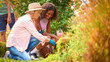 © Monkey Business - Teenage Granddaughter Helping Grandmother With Gardening At Home Learning About Plants And Nature