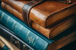 © Tohamina - Leather-bound journal among academic books close-up on personal wisdom alongside formal education