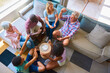 © Monkey Business - Overhead Shot Of Three Generation Family Indoors At Home In Lounge Playing Game Of Cards Together