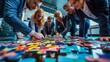 © alphaspirit - Swedish professionals working together to arrange vibrant puzzle pieces on a table