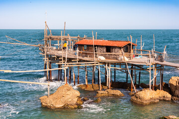 Wall Mural - Traditional wooden fishing house with a net near sea coast