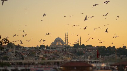 as the sunset casts a golden hue over istanbul, the city center comes alive against the backdrop of 