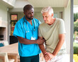 © Monkey Business - Male Nurse Visiting Senior Man Using Walking Stick With Mobility Issues At Home