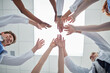 © peopleimages.com - Doctor, hands and below with medical team for meeting, unity or motivation at hospital. Low angle or closeup of people or group reaching or touching in collaboration, solidarity or mission at clinic