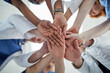 © peopleimages.com - Doctor, hands together and below with medical team for meeting, unity or motivation at hospital. Low angle or closeup of group piling or touching in collaboration, solidarity or mission at clinic