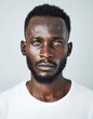 © Maelgoa - ID Photo for Passport : African young adult man with straight short black hair and blue eyes, medium beard, without glasses and wearing a white t-shirt