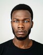 © Maelgoa - ID Photo for Passport : African young adult man with straight short black hair and blue eyes, short beard, without glasses and wearing a black t-shirt