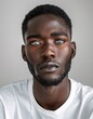 © Maelgoa - ID Photo for Passport : African young adult man with straight short black hair and blue eyes, short beard, without glasses and wearing a white t-shirt