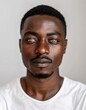 © Maelgoa - ID Photo for Passport : African adult man with straight short black hair and blue eyes, thin mustache, without glasses and wearing a white t-shirt