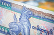 Myanmar money, 100 Burmese kyat banknote against the background of the world, financial market concept