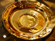 A gold bowl on a glass table.