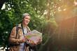 © peopleimages.com - Asian man, map and city travel for directions or urban sightseeing in China, searching or reading. Male person, paper and guide for outdoor tourism for weekend journey or park, location or geography