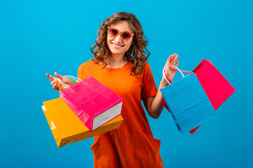 Wall Mural - attractive happy smiling stylish woman holding shopping bags