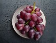 Red grapes with drops of water on white plate. Top view. Fruits and summer berries illustration