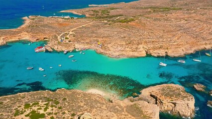 Wall Mural - Aerial drone view of Blue lagoon  and boats on Comino island, part of Maltese island