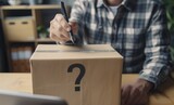 Fototapeta Przestrzenne - A man is writing on a box with a question mark on it