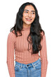 © Krakenimages.com - Hispanic teenager girl with dental braces wearing casual clothes looking away to side with smile on face, natural expression. laughing confident.