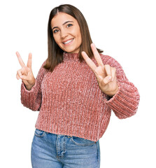 Canvas Print - Young beautiful woman wearing casual clothes smiling looking to the camera showing fingers doing victory sign. number two.