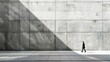 © Cloudyew - A man walks down a sidewalk in front of a large concrete wall. The wall is covered in cracks and has a faded gray color