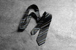 One striped necktie on grey textured background, top view