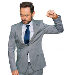 Sticker - Middle age man wearing business clothes strong person showing arm muscle, confident and proud of power