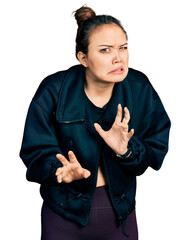 Canvas Print - Young hispanic girl wearing sportswear disgusted expression, displeased and fearful doing disgust face because aversion reaction.