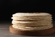 Many tasty homemade tortillas on wooden table