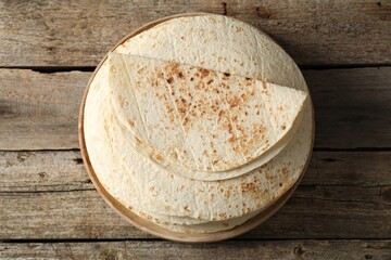 Wall Mural - Stack of tasty homemade tortillas on wooden table, top view