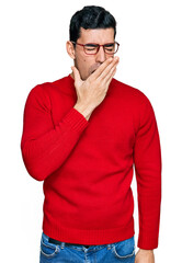 Wall Mural - Handsome hispanic man wearing casual clothes and glasses bored yawning tired covering mouth with hand. restless and sleepiness.