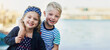 © peopleimages.com - Happy, siblings and hug in outdoor for portrait with love, bonding and family, holiday and beach in summer for memory. Smile, boy and girl, kids and adventure, together and relationship with care