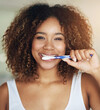 © peopleimages.com - Black woman, portrait and smile with toothbrush for teeth in bathroom with dental hygiene in house. Happy, morning and everyday routine with refreshing breath, getting ready and care with daily habit