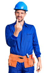 Poster - Young handsome man wearing worker uniform and hardhat beckoning come here gesture with hand inviting welcoming happy and smiling