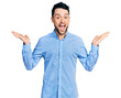 © Krakenimages.com - Hispanic man with beard wearing casual business shirt celebrating crazy and amazed for success with arms raised and open eyes screaming excited. winner concept
