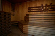 © Евгений Вершинин - A hardwood sauna with a plank ceiling, brick wall, and stairs