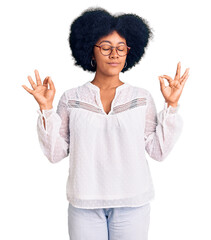 Poster - Young african american girl wearing casual clothes relax and smiling with eyes closed doing meditation gesture with fingers. yoga concept.