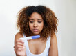 Black woman, anxiety and fear in house with pregnancy test for baby, infertility and future family. Girl, stress and scared with testing kit in home for motherhood, child and ivf results by mockup