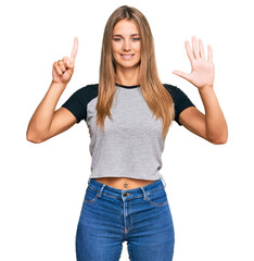 Sticker - Young blonde woman wearing casual clothes showing and pointing up with fingers number six while smiling confident and happy.