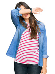 Sticker - Young brunette woman wearing casual clothes covering eyes with arm, looking serious and sad. sightless, hiding and rejection concept