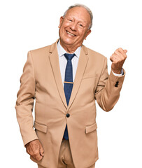 Canvas Print - Senior caucasian man wearing business suit and tie smiling with happy face looking and pointing to the side with thumb up.