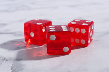 Sticker - Three red game dices on white marble table, closeup