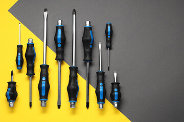 Poster - Set of screwdrivers on color background, flat lay. Space for text