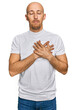 © Krakenimages.com - Bald man with beard wearing casual white t shirt smiling with hands on chest with closed eyes and grateful gesture on face. health concept.