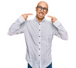 © Krakenimages.com - Bald man with beard wearing business shirt and glasses smiling cheerful showing and pointing with fingers teeth and mouth. dental health concept.