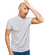 © Krakenimages.com - Bald man with beard wearing casual white t shirt surprised with hand on head for mistake, remember error. forgot, bad memory concept.