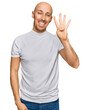 © Krakenimages.com - Bald man with beard wearing casual white t shirt showing and pointing up with fingers number four while smiling confident and happy.